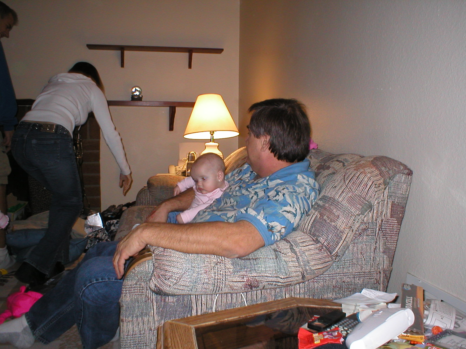 Grandpa Dave & Kaylin.  Momma is chasing after Paige who is stuck between the couch and the table.