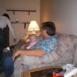 Grandpa Dave & Kaylin.  Momma is chasing after Paige who is stuck between the couch and the table.