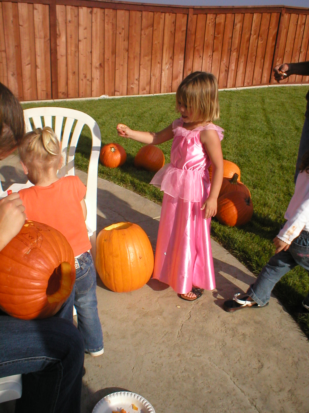 Caitlyn carving her pumpkin, pulling the goo out