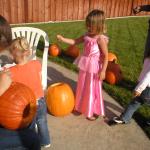 Caitlyn carving her pumpkin, pulling the goo out